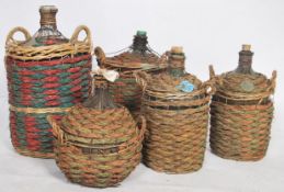 An unusual collection of 5 Spanish olive picking bottles, all of graduating sizes and being