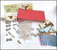 A large group of various ephemera to include a good group of vintage stamps, various postcards and