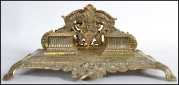 A large 19th century Victorian brass desk top tidy twin inkwell. Letter rack with twin wells and pen