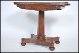A Regency 19th century mahogany games / card table being raised on a quadruped base with inverted