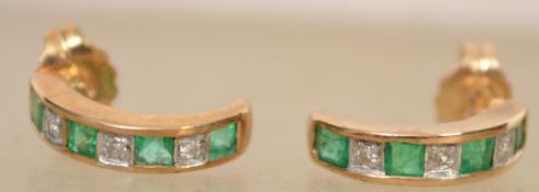 A pair of 9ct gold, emerald and diamond ladies half moon shaped earrings being pave set complete