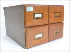 A 1920's oak 4 drawer industrial index filing cabinet, each drawers with pulls and notation slides