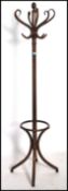 A vintage 20th century Thonet style bentwood hat stand being raised on splayed legs with s-shaped