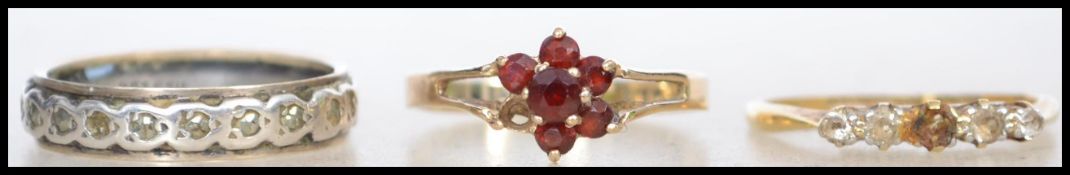 A collection of ladies gold rings one being 18ct gold, one gold and silver band and a 9ct gold