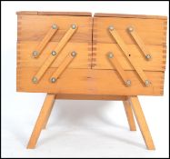 A vintage 20th century retro cantilever sewing box with 5 inner compartments. Measures 33cms tall.