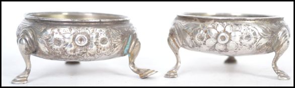 A pair of believed 18th century silver hallmarked English silver salts raised on cabriolet legs with