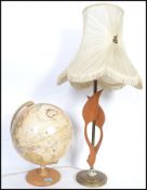 A vintage teak wood retro globe together with a retro brass column table lamp