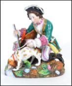 A presumably 19th century continental porcelain figurine - diorama with huntsman and hound.