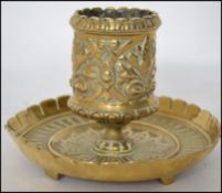 A 19th century Art Nouveau brass candlestick of stub form by Jenner and Knewstub St James Street