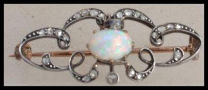 A Victorian Art Nouveau 9ct gold and silver diamond and opal brooch having an articulating