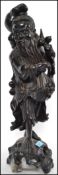 A large 19th century Chinese hardwood carved figure of a sage / immortal being raised on a pierced
