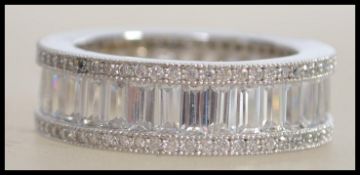 A ladies contemporary silver and cz adorned full eternity band ring complete in the presentation