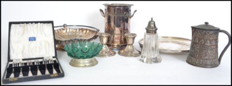 A collection of early to mid 20th century silver plated wares to include sugar shaker, stub candle