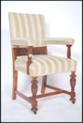 An early 20th century carved oak throne armchair raised on turned legs with h-stretchers having
