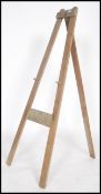 A vintage 20th century Triang artists folding easel with plaque to top.