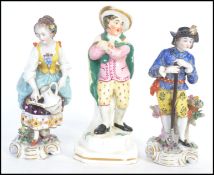 A collection of 3 figurines to include a Staffordshire figurine and 2 others with gold anchor