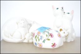 A Minton cat in a seated position in the Haddon Hall pattern along with a Coalport Mother Love cat