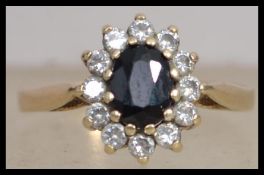 A hallmarked 9ct gold cluster ring with central ov