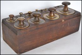 A good set of 19th century brass weights complete with the wooden stand having inset spacers. The