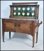 An Edwardian Art Nouveau oak and tile top marble washstand. The cabinet with twin doors having