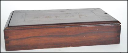 An early 20th century Oriental Mahjong set, the pieces of bone and bamboo construction held within