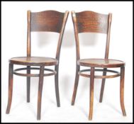 A pair of early 20th century Thonet cafe chairs raised on turned legs with upper peripheral