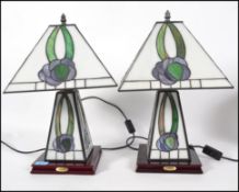 A pair matching reproduction Tiffany style table lamps, coloured leaded light glass shades with