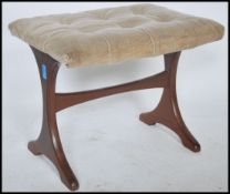 A 1970's retro G-Plan teak wood dressing table stool being raised on angular supports united by