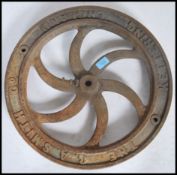 A vintage Industrial cast iron dram / dolly wheel being marked for the GA Smith Co Kettering