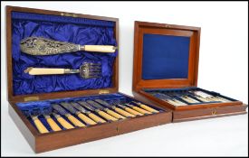 An Edwardian mahogany silver hallmarked collar cased fish serving knife and fork with matching 6