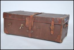 A vintage 20th century canvas leather and wooden bound steamer trunk complete with inner lid and key