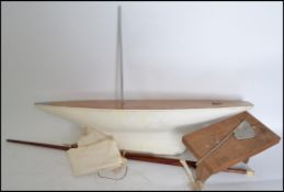 A vintage early 20th century pond yacht - sailing boat with painted wooden hull complete with mast,