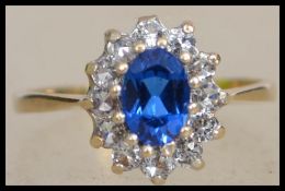 A hallmarked 9ct gold cluster ring set with a cent