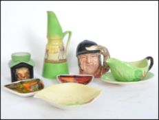 A collection of ceramics to include two Poole gemstone / fat lava pin trays, Carlton Ware leaf