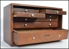 A cased 20th century engineers toolbox with fall front having sectional drawers within having some
