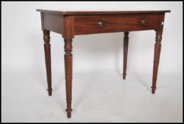 A Victorian 19th century mahogany writing table desk being raised on turned legs with a fitted