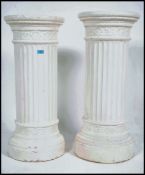 A large pair of neo-classical ceramic white painted bust stands / plant stands having columns with