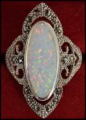 A large silver and opal ladies dress ring of contemporary form being complete in the original