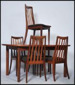 A 20th century G-Plan teak wood dining table and chairs of good quality. The extending table