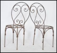 A pair of 20th century wrought iron garden chairs