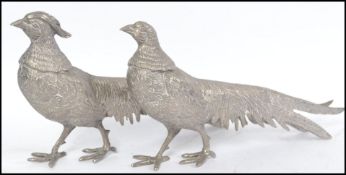A pair of silver plated table top ornaments in the form of pheasants dating to the mid 20th century