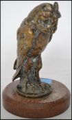 A good early 20th century cold painted cast bronze owl in the manner of Bergman. Set to a round