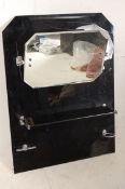 A 1930s Art Deco black glass bathroom mirror with original chrome fittings and glass shelf in good