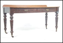 A large late Victorian mahogany writing table desk being raised on turned legs and ceramics