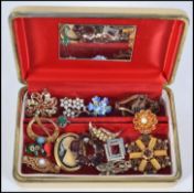 A collection of vintage costume jewellery brooches to include cameo, rhinestone spray, porcelain