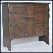 An unusual mid century Arts & Crafts oak dresser base cabinet having shaped sides and flared top