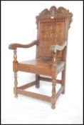 A believed 19th century carved oak Wainscott chair - armchair being raised on turned legs united