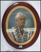 An early 20th century oval photographic portrait study with handpainted oil finish. The portrait