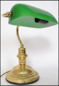 A 20th century contemporary green glass and brass bankers desk lamp having glass rectangular shade