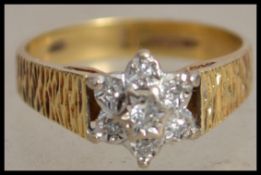 A hallmarked 18ct gold and diamond cluster ring wi